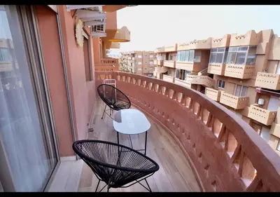 two chairs and a table on a balcony with boxes at Havre de paix au bord de mer in Pont Blondin