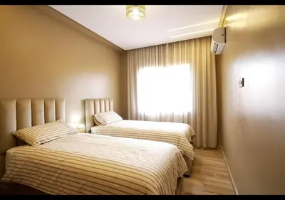 two beds in a small room with a window at Havre de paix au bord de mer in Pont Blondin