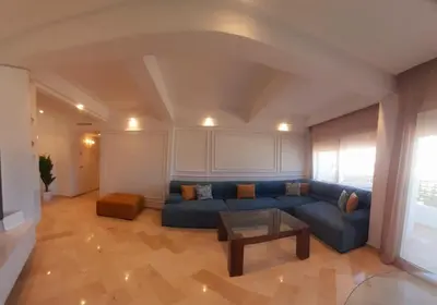 a living room with a blue couch and a table at Appartamento Narjis in Casablanca