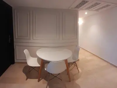 a white table and chairs in a room at Appartamento Narjis in Casablanca