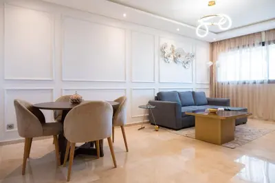 a living room with a table and a couch at 2BR Prestigia Hay Riad 13 mintues city center in Rabat