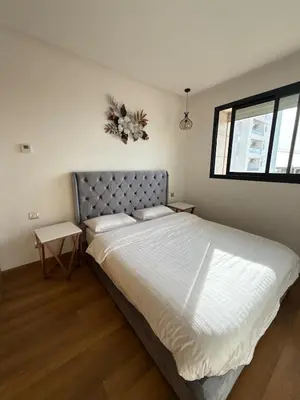 a bedroom with a large bed and a window at 2BR Prestigia Hay Riad 13 mintues city center in Rabat
