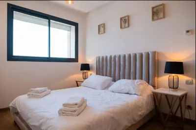 a bedroom with a bed with towels on it at 2BR Prestigia Hay Riad 13 mintues city center in Rabat