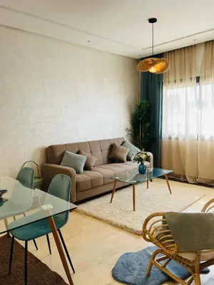 a living room with a couch and a table at Elegant & Cozy Beach Apartment in Mohammedia