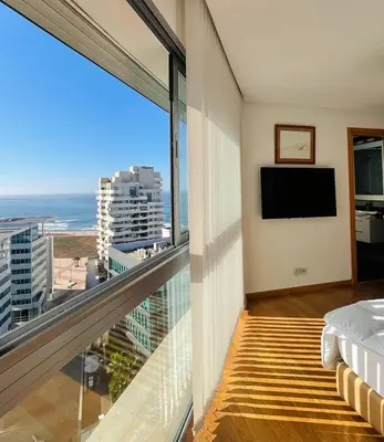 a bedroom with a balcony with a view of the ocean at Élégance et Vue sur l'Océan in Casablanca