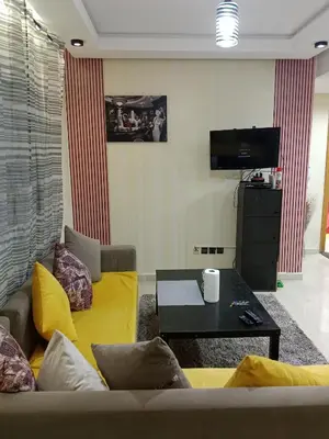 a living room with a couch and a table at Résidence journalière chic Casablanca in Casablanca