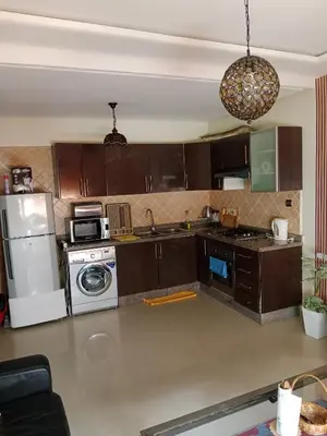 a kitchen with a refrigerator and a washer and dryer at La maison de rêve in Casablanca