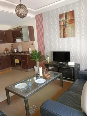 a living room with a table and a couch at La maison de rêve in Casablanca