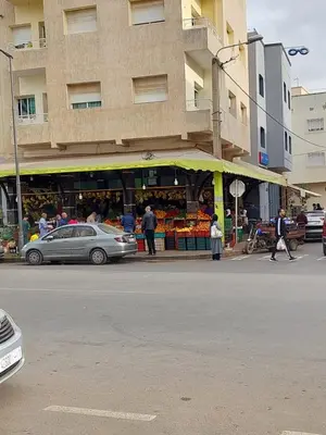 a market with a car parked in front of a building at Dar Indigo in Temara