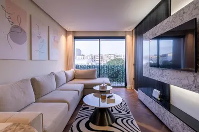 a living room with a couch and a tv at Appartement luxueux plein centre Casablanca - 2 Personnes in Casablanca