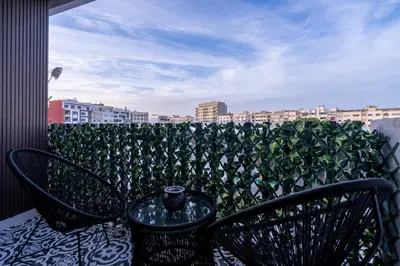 a balcony with two chairs and a view of a city at Appartement luxueux plein centre Casablanca - 2 Personnes in Casablanca
