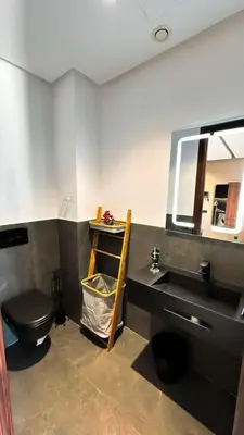 a bathroom with a sink and a toilet and a mirror at Carpediem in Casablanca