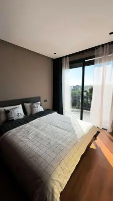 a bedroom with a large bed with a large window at Carpediem in Casablanca