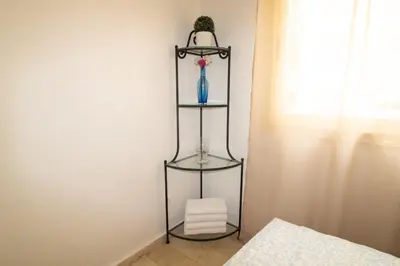 a black shelf with a blue vase and a window at Horizon Mogador home in Casablanca