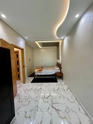 a room with a bed on a marble floor at Appartement haut standing, 2 chambres - Mohammedia in Mohammedia