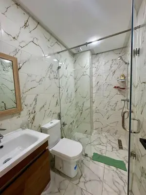 a bathroom with a shower and a toilet and a sink at Appartement haut standing, 2 chambres - Mohammedia in Mohammedia