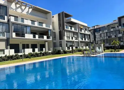a swimming pool in front of some apartment buildings at Évasion de luxe Tamaris in Tamaris