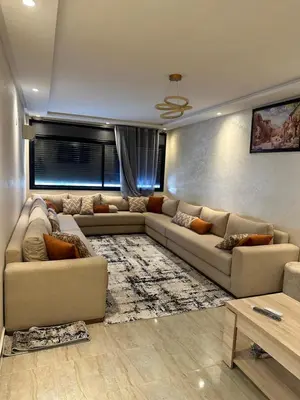 a living room with two couches and a rug at appartement a 1 min de la plage in Casablanca