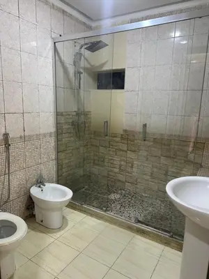 a bathroom with a shower and a toilet and a sink at appartement a 1 min de la plage in Casablanca