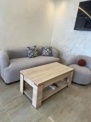 a living room with a couch and a coffee table at appartement a 1 min de la plage in Casablanca