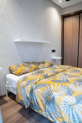 a bedroom with a bed with a colorful blanket at Appart familial cœur Casa in Casablanca