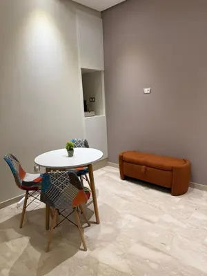 a room with a table and chairs and a couch at Studio Perla Sofé in Nouaseur
