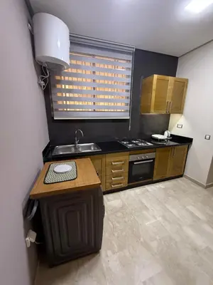 a small kitchen with a sink and a stove at Studio Perla Sofé in Nouaseur