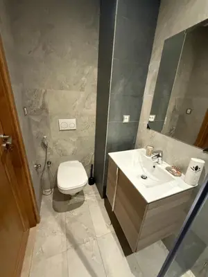 a bathroom with a sink and a toilet and a mirror at Studio Perla Sofé in Nouaseur