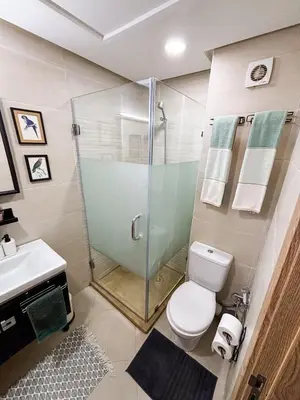 a bathroom with a shower and a toilet and a sink at Escapade Tropicale at Jardins Cherrat in Bouznika Bay in Bouznika