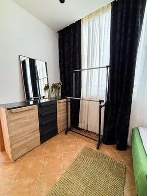 a living room with a dresser and a window at Escapade Tropicale at Jardins Cherrat in Bouznika Bay in Bouznika