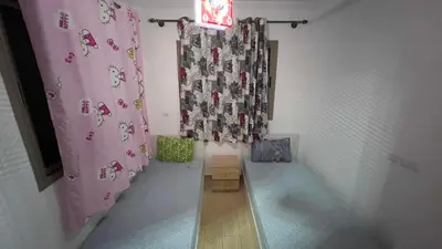 a room with a pink shower curtain and a room with at Yasmine Beach in Mansouria
