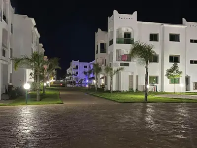a flooded street in front of buildings at night at Yasmine Beach in Mansouria