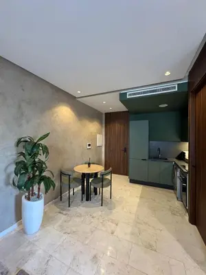 a dining room with a table and chairs and a kitchen at Luxury Studio Oasis in Casablanca