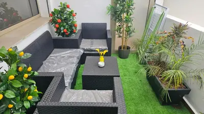 a balcony with a table and chairs and plants at Bright 2BR Apartment in Maârif, Ideal for Families & Business Travelers in Casablanca