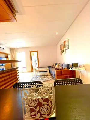 a living room with a couch and a table at Seaside appartment with private pool in Tamaris