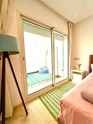 a bedroom with a large window with a bed and a balcony at Seaside appartment with private pool in Tamaris