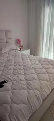 a large white bed in a room with a window at Al yakoute in Mansouria