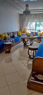 a living room with a couch and a table at Al yakoute in Mansouria