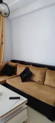 a couch with pillows on it in a room at Al yakoute in Mansouria