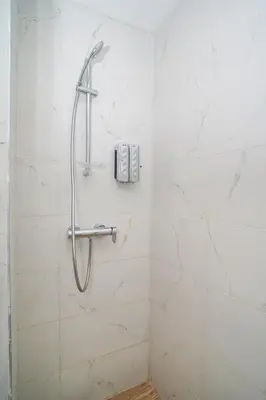 a shower in a bathroom with white tiles at Domaine d'Anfa - Luxe & Mer in Casablanca