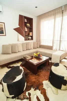 a living room with a couch and a table at Domaine d'Anfa - Luxe & Mer in Casablanca