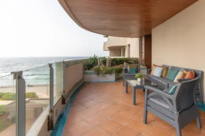 a balcony with chairs and a view of the ocean at شقة فاخرة - Luxury apartment in Casablanca