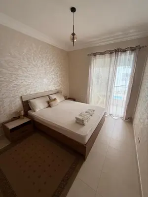 a bedroom with a bed and a large window at Plage manesmann in Mohammedia