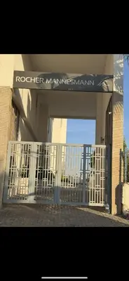 an entrance to a building with a white gate at Plage manesmann in Mohammedia