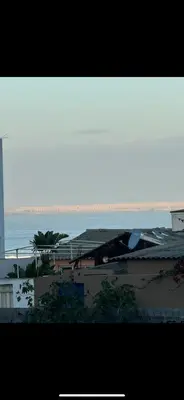 a view of the ocean from a balcony of a building at Plage manesmann in Mohammedia