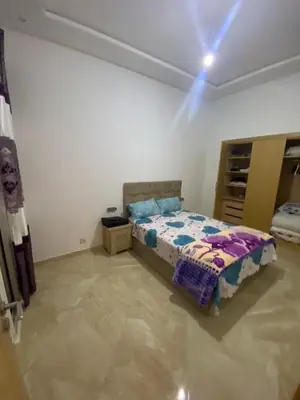 a bedroom with a bed in a room at Appartement de haut standing,4 piscines in Bouznika