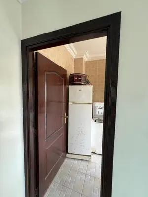 a door leading into a kitchen with a refrigerator at Chambre zuiten in Casablanca