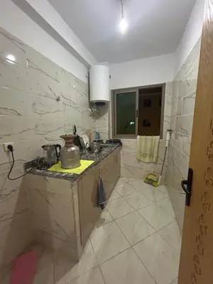 a kitchen with a sink and a counter top at Appartement meublé calme et chaleureuse in Temara