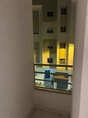 a room with a window with a view of a building at Appartement meublé calme et chaleureuse in Temara