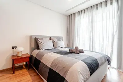 a bedroom with a large bed and a large window at C04 Comfort & Design Studio with Private Terrace CFC in Casablanca